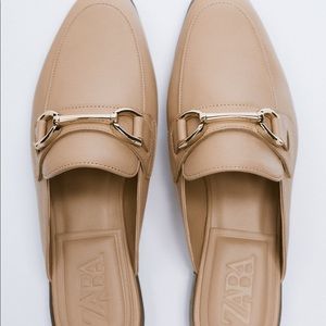 Zara nude mules with gold buckle.